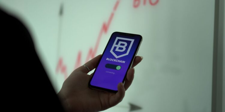 Hand holding a phone with a blockchain wallet app, the setup needed for the Axie Marketplace