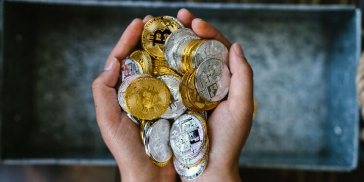 Hands holding crypto coins, illustrating GameFi token rewards