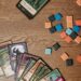Fantasy trading cards and tokens on a wooden table, the style of play in Gods Unchained