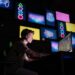 Gamer playing a web3 game on a PC in a neon-lit room