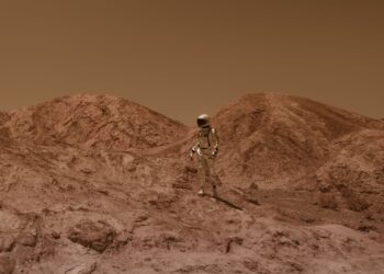 Person in a spacesuit walking across a barren, Mars-like landscape